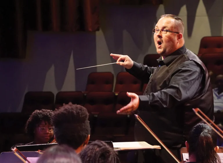 Chad McClellan conducting students playing instruments