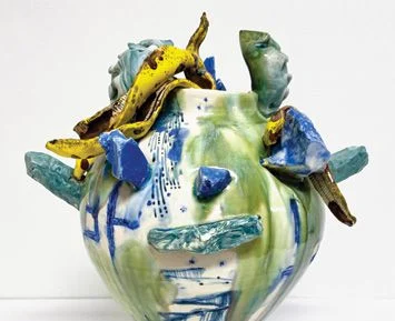 An abstract sculpture in blues, greens, whites and yellows