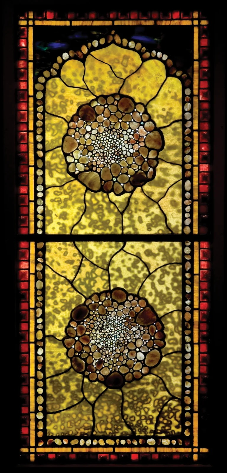 A yellow, red and black floral stained-glass window