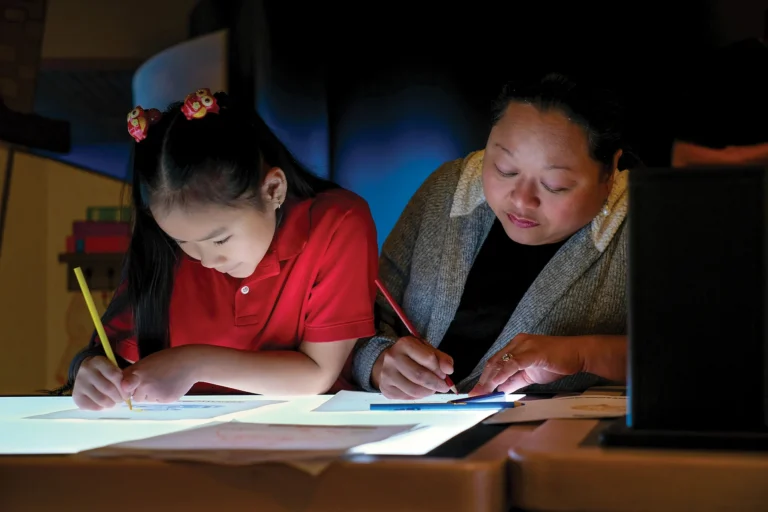 Children drawing on a lightboard