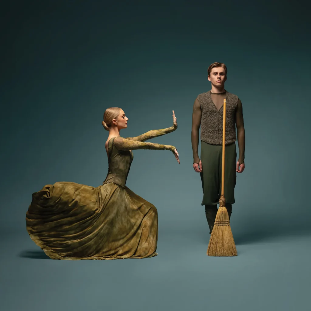 Two dancers strike statue-like poses