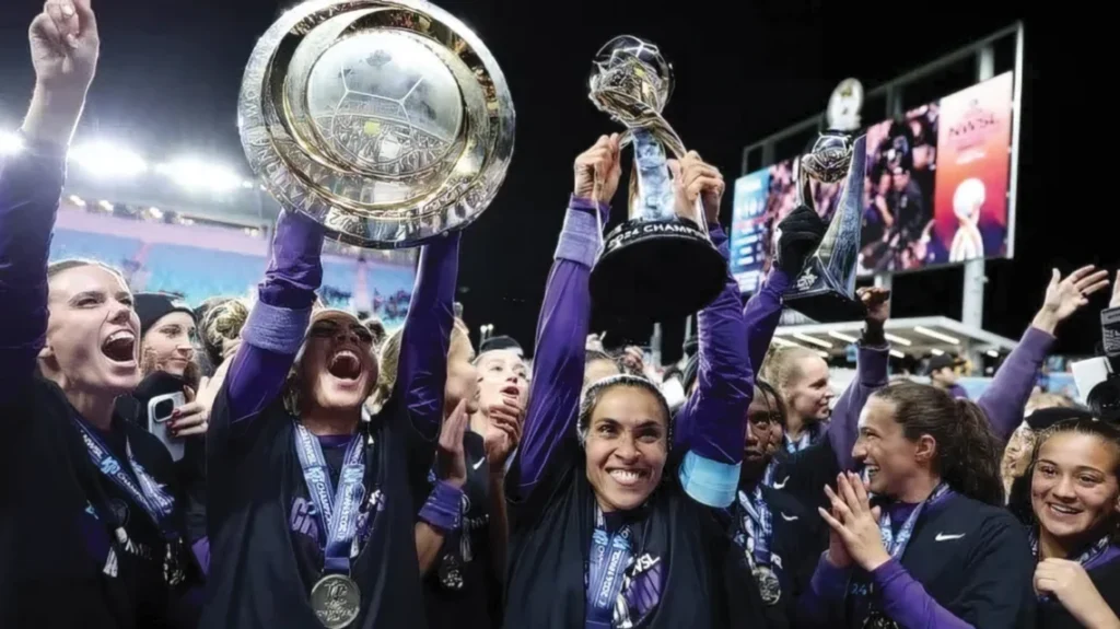A soccer team holding trophies