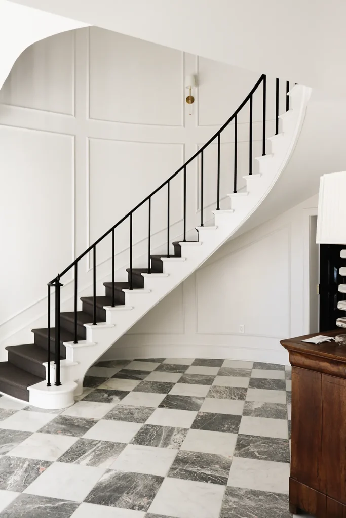 An elegant curving black and white staircase