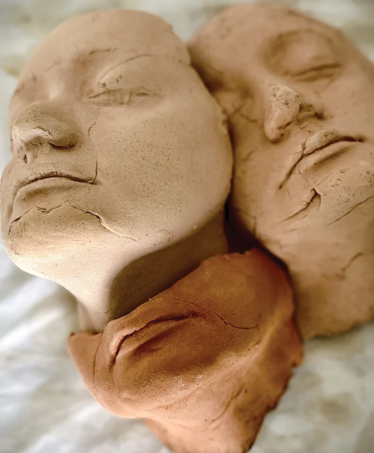Artwork of faces with closed eyes in natural tones
