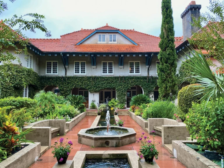 A mansion house surrounded by lush gardens