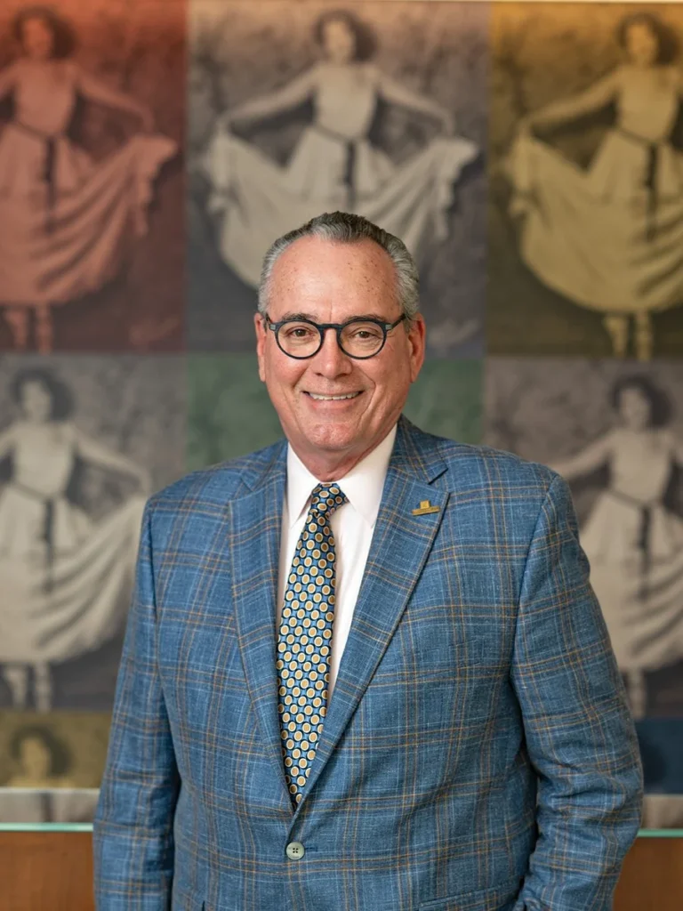 David Odahowski in a blue plaid suit and glasses