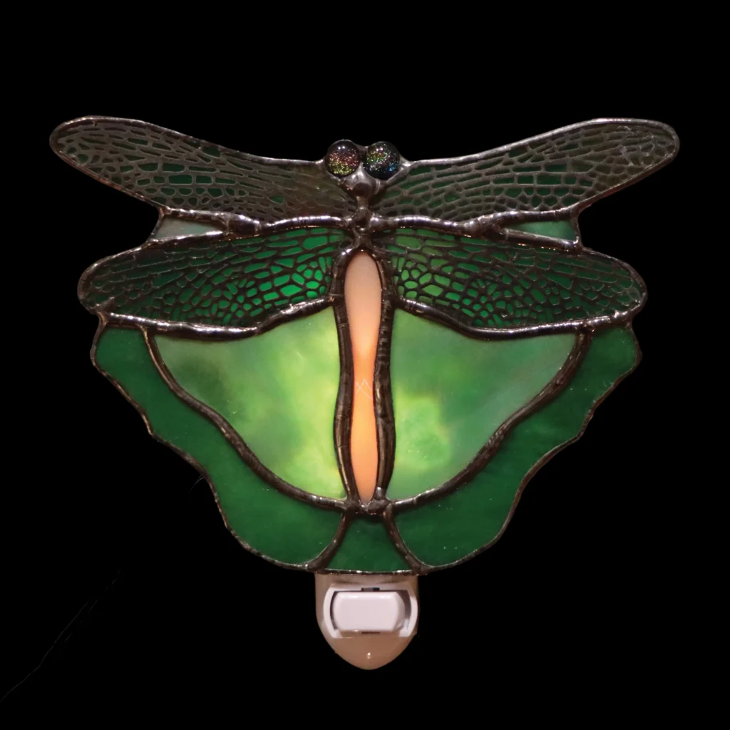 Stained-glass dragonfly night light glowing green