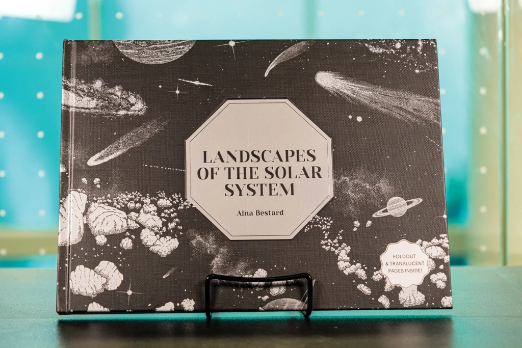 Landscapes of the Solar System coffee-table book on a stand