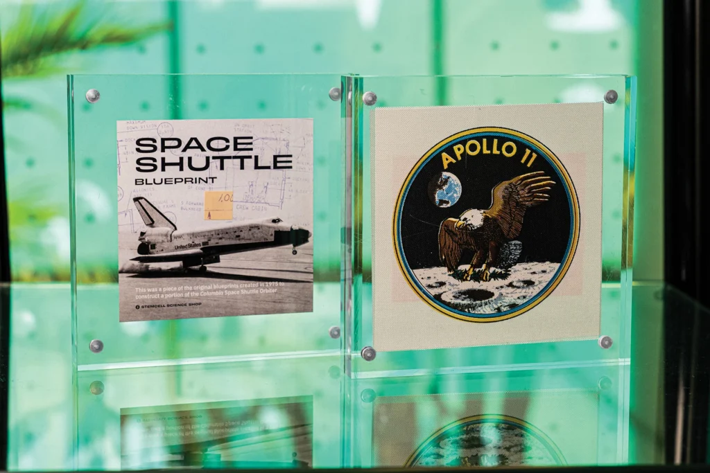 Framed Space Shuttle blueprint fragment and Apollo 11 insignia