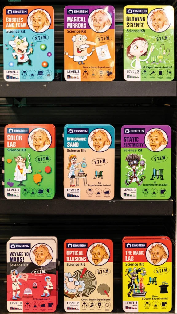 Rack of colorful Einstein science activity kits