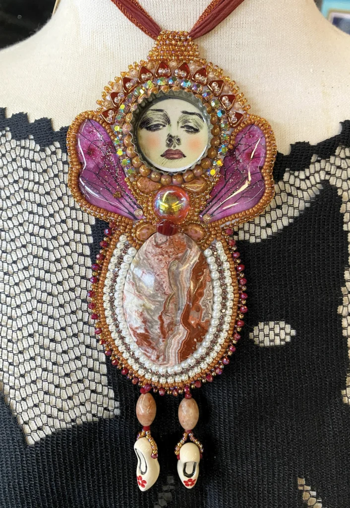 Beaded butterfly necklace with a painted face