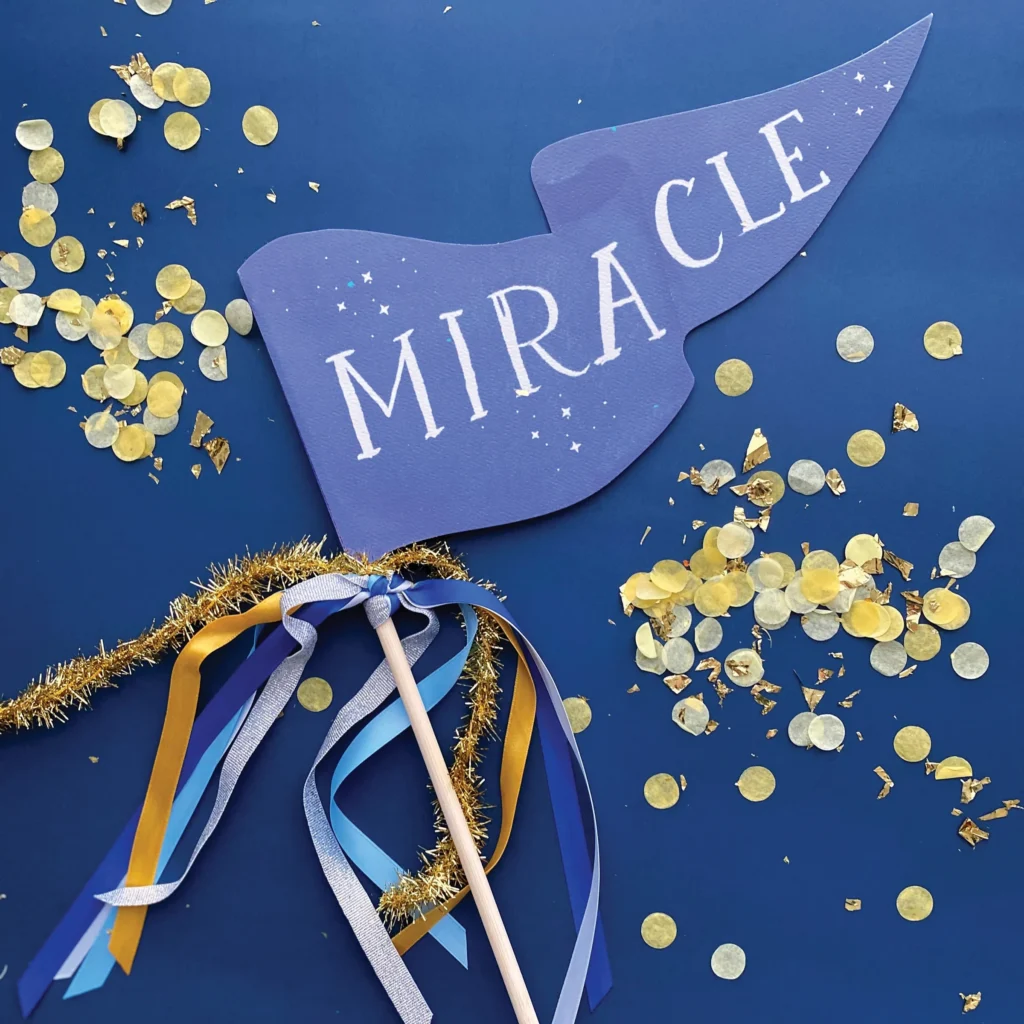 Blue Miracle Hanukkah party pennant on a dowel with ribbons
