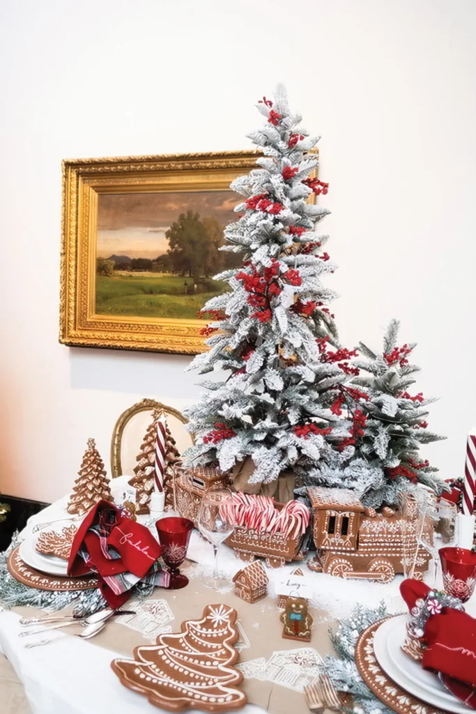 Festival of Trees display with a flocked tree and gingerbread tablescape