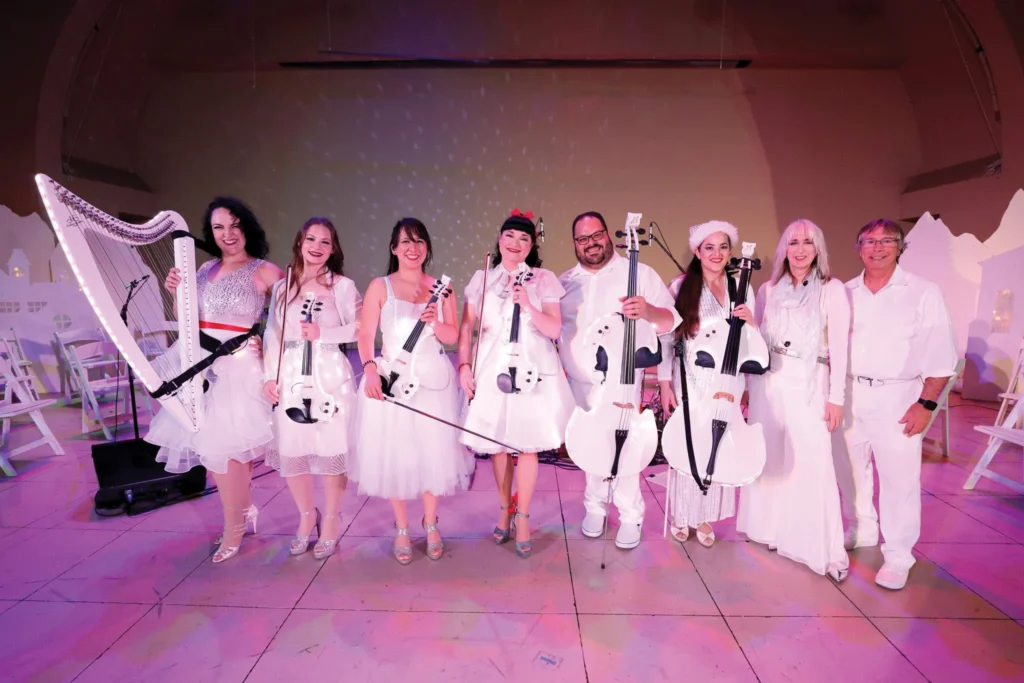 Violectric musicians in white with illuminated electric string instruments