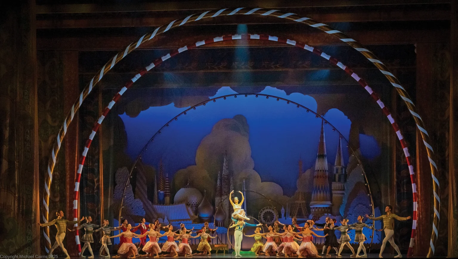 Orlando Ballet dancers on a lavish Nutcracker stage set framed by a candy-striped arch