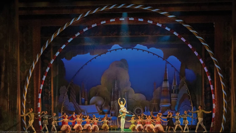 Orlando Ballet dancers on a lavish Nutcracker stage set framed by a candy-striped arch